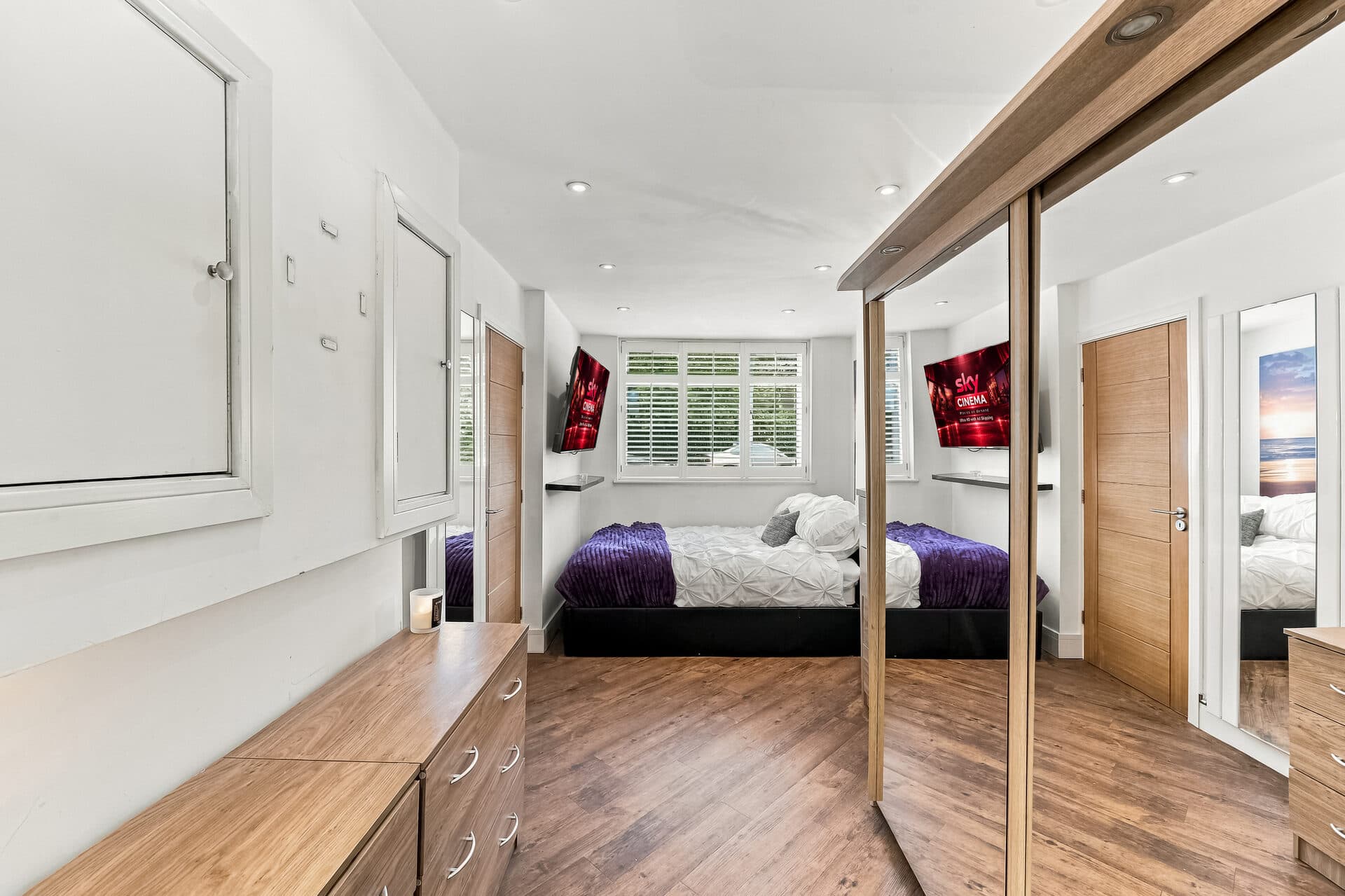 Double bedroom with wall-mounted smart TV