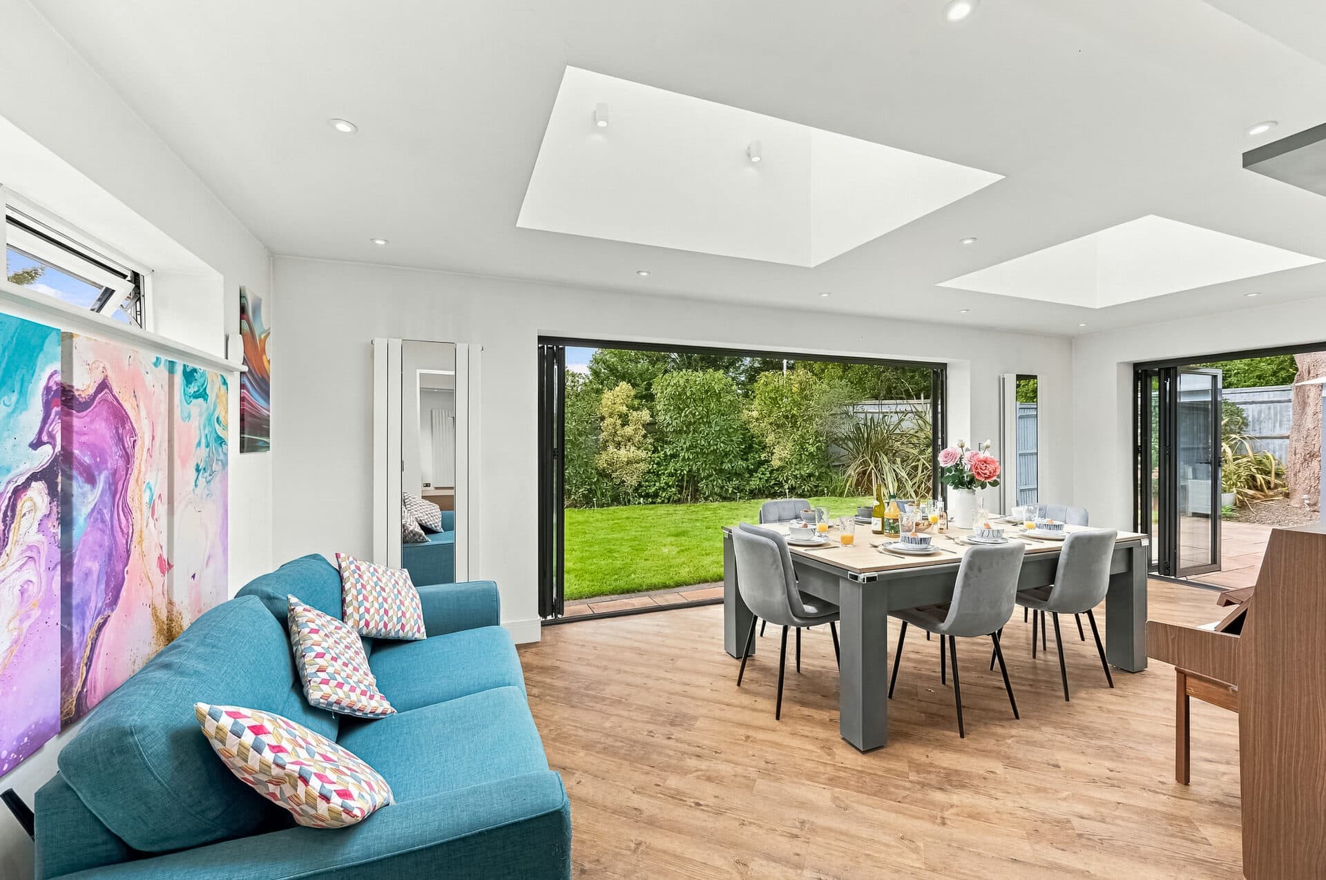 Living and dining area opening onto the garden through bi-fold doors